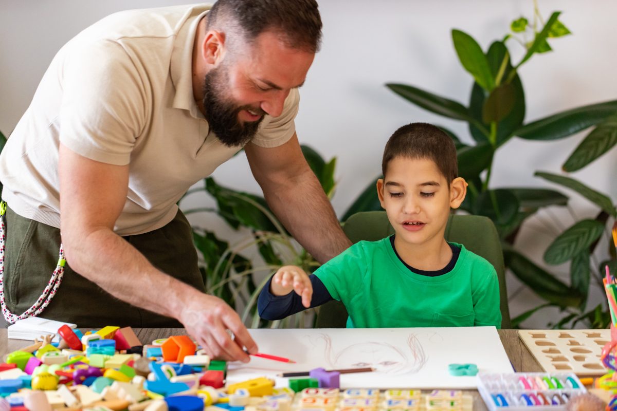 aba therapist supporting child with autism